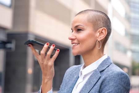 Side view portrait beautiful business woman smiling talking on smartphone outdoors.
