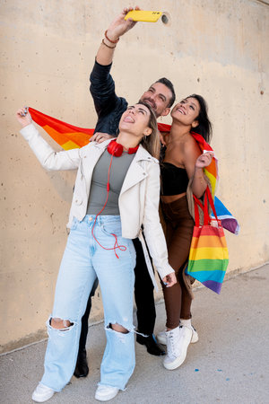 Happy multiethnic group of young gay friends take a selfie together outdoors.の写真素材