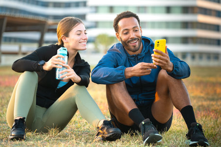 Young athletes using apps on the phone to keep track of their exercise routine.