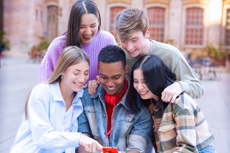 Students having fun with mobile phones creating content on social media.の写真素材