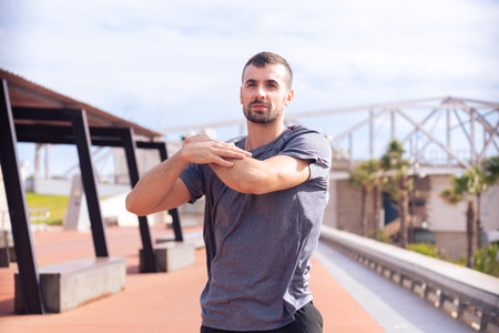Male runner in warm-up stretch for running or cardio exercise.outdoors.の写真素材