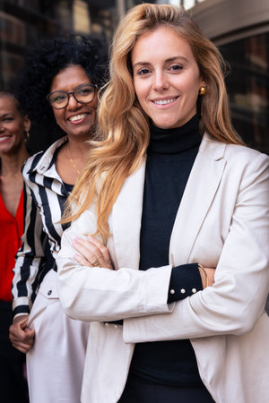 Team of multiracial and diverse businesswomen posing in a row smiling for the camera.の写真素材