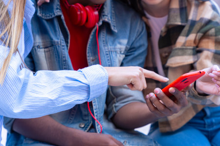 Three students having fun with mobile phones creating content on social media.の写真素材