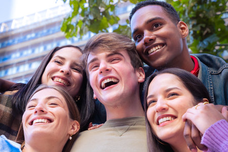 Group of happy and smiling multiethnic friends looking at camera.