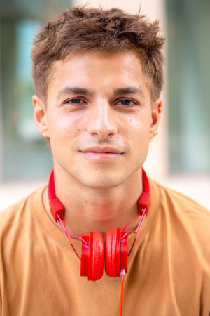 Young Man with Red Headphones and Neutral Expression.Verticalの写真素材