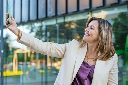 Smiling Woman Taking a Selfie Outdoorsの写真素材