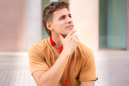 Young Man Thinking and Looking to the Side.Verticalの写真素材