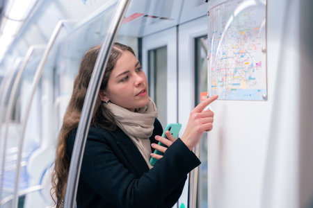 Young Woman Checking Subway Map While Using Smartphone