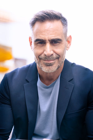 Confident Businessman Smiling in Modern Cityscape.Verticalの写真素材