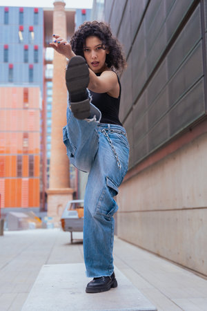 Woman dancing outdoors in urban modern spaceの写真素材