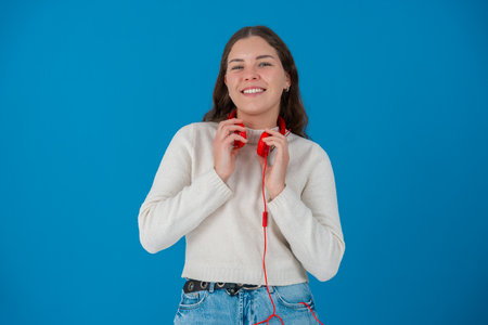 Portrait Cheerful Young Woman Smiling with Red Headphones Around Neck