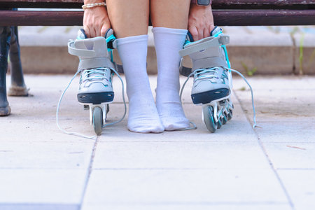 Rollerblades on the ground with unrecognizable person in white socks close upの写真素材