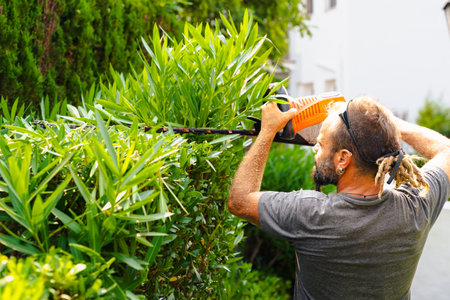 Young couple back to back with angry male and smiling female, red background studioの写真素材