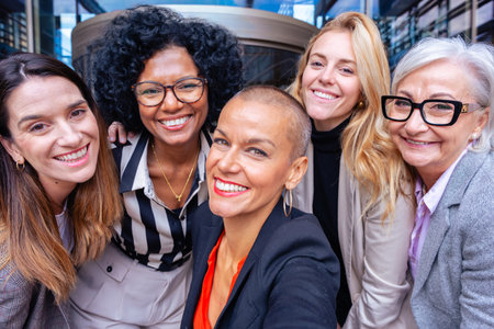 Group of diverse businesswomen smiling outdoors, teamwork and confidence.の写真素材