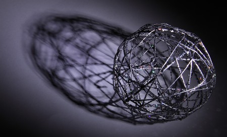 Black plaited sphere with shadowの写真素材
