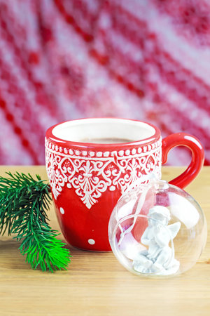 Cup of hot cocao with christmas glass toy and pineの写真素材