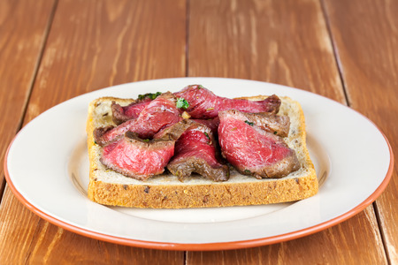 Bread toast with roastbeef on plateの写真素材