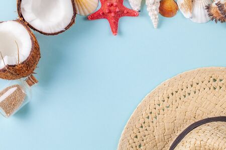 Flat lay composition with beautiful starfishes, sea shells, coconut, straw hat and bottle with sand...