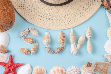 The word sun written in shells on blue background