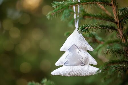 Close-up of Christmas decoration toy shaped like a fir tree, bokeh background