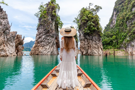Young Female Tourist in Hat at Longtail Boat Exploring Turquoise Cheow Lan Lake