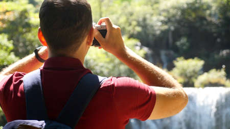 Wanderlust, tourism concept. Happy male tourist with backpack in travel. Young man traveler make...