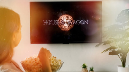 Woman relaxing at home and watching on TV House of the Dragon