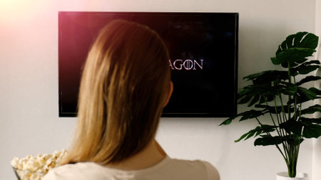 Woman relaxing at home and watching on TV House of the Dragonのeditorial素材
