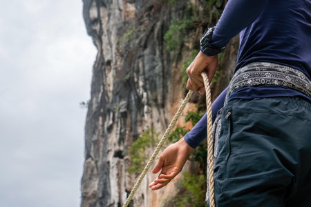 Sailor pulling rope in during traveling on ship vesselの写真素材