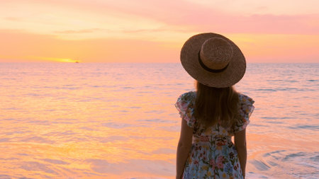 Slow motion of a female tourist standing at a stunning beach in Thailandの写真素材