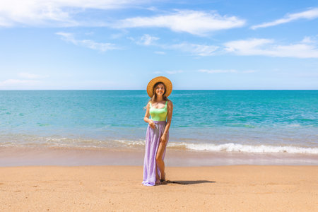 Attractive woman in swimwear on the beach or ocean, relaxes on vacationの写真素材