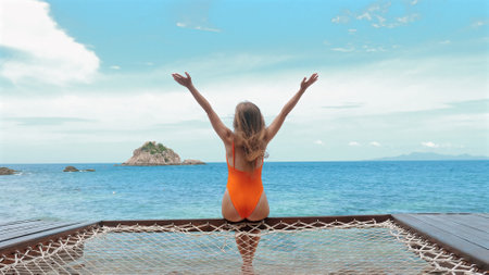 Young woman enjoys day at beach in Thailand.