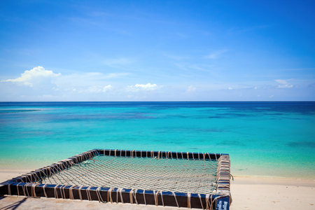 Tropical beach with turquoise water and photo spot with hammockの写真素材