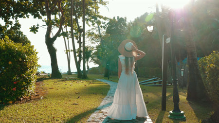 Traveler woman relaxing on a tropical beach at a luxury resort.の写真素材