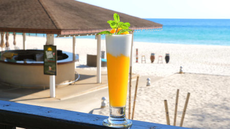 Refreshing tropical cocktail on beachside bar counter with pristineの写真素材