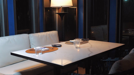 Cozy restaurant table setting with ambient lighting, napkins, andの写真素材