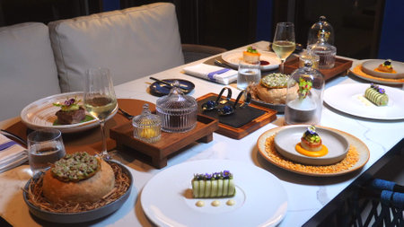 Beautifully arranged fine dining table set for gourmet meal, featuringの写真素材