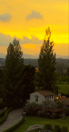 Sunset view over idyllic countryside villa, surrounded by lushの写真素材