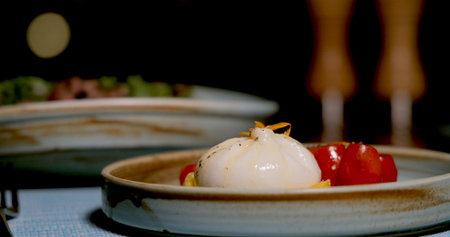 Burrata cheese with cherry tomatoes on ceramic plate, Italianの写真素材