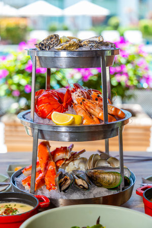 Seafood platter served on ice, featuring oysters, lobster, shrimp,の写真素材