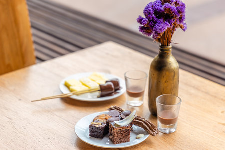 Rustic table setting featuring chocolate desserts, purple flowers inの写真素材