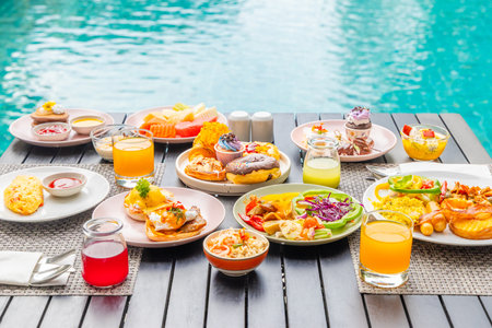 Delicious breakfast spread by pool with colorful fruits, pastries,の写真素材