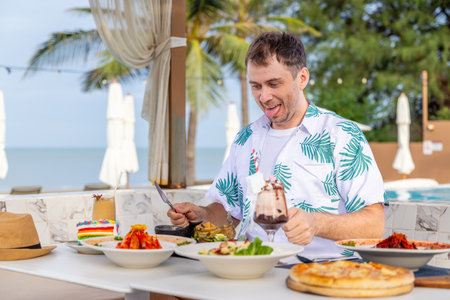 Man enjoying outdoor dining by pool with diverse dishes and desserts,の写真素材