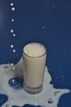 Splashing milk out of the glass.の写真素材