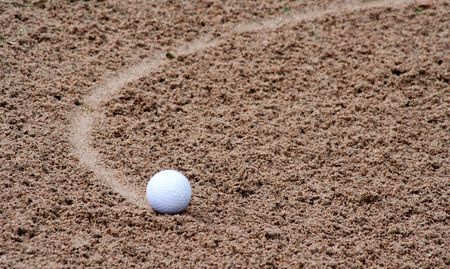 Golfball in bunkerの写真素材