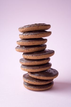 Pile of delicious chocolate cookies on pink background
