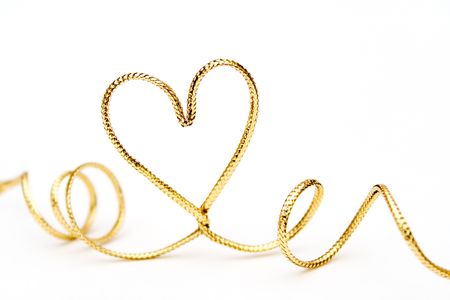 Golden ribbon bended to heart shapeの写真素材