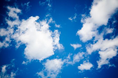 Dark blue sky with white cloudsの写真素材
