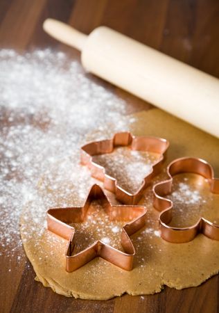 Baking christmas cookies with star and tree motifの写真素材