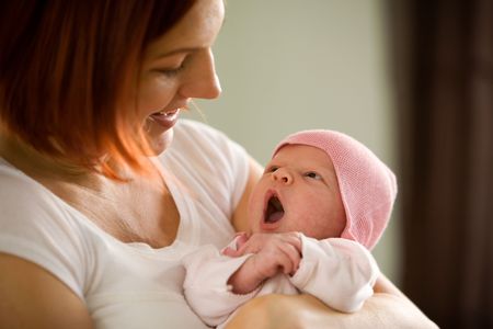 Mother holding newborn baby girlの写真素材
